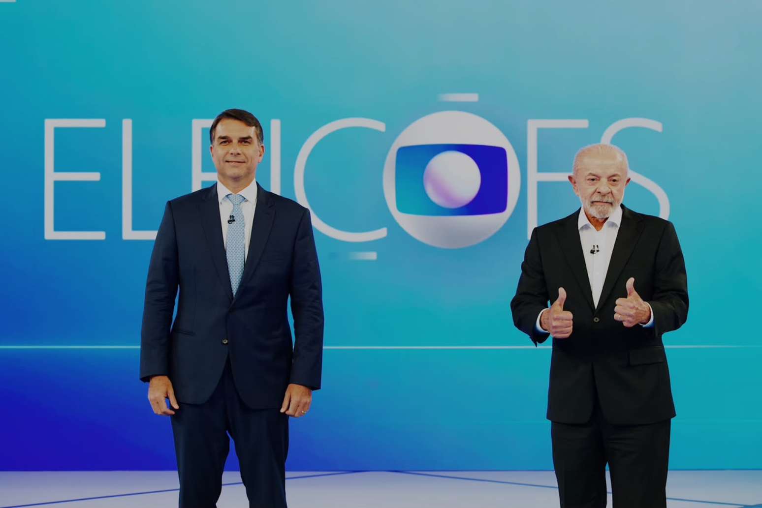 Fl&aacute;vio Bolsonaro e Lula durante debate da Globo