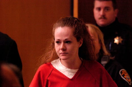 Death row inmate Christa Pike, in red jumpsuit, walks ahead of an officer in court