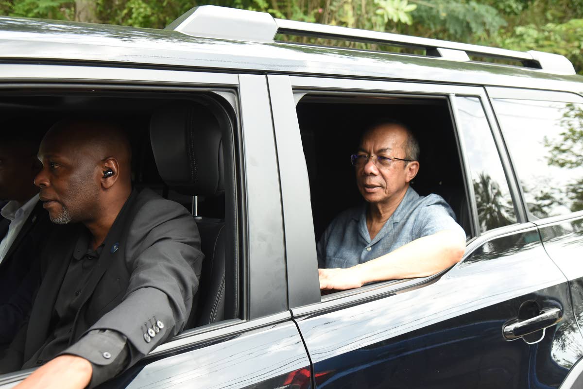 Minister of National Security and Peace Dr Horace Chang leaving the scene where a member of the Jamaica Constabulary Force (JCF) was fatally shot and two colleagues wounded during an operation in St Catherine on Friday. Three suspected gunmen were also kil