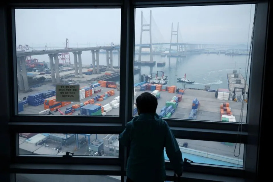A woman looks at cranes and shipping containers from an observation platform at Pyeongtaek port in Pyeongtaek, South Korea, April 2, 2025. REUTERS/Kim Hong-Ji · Reuters